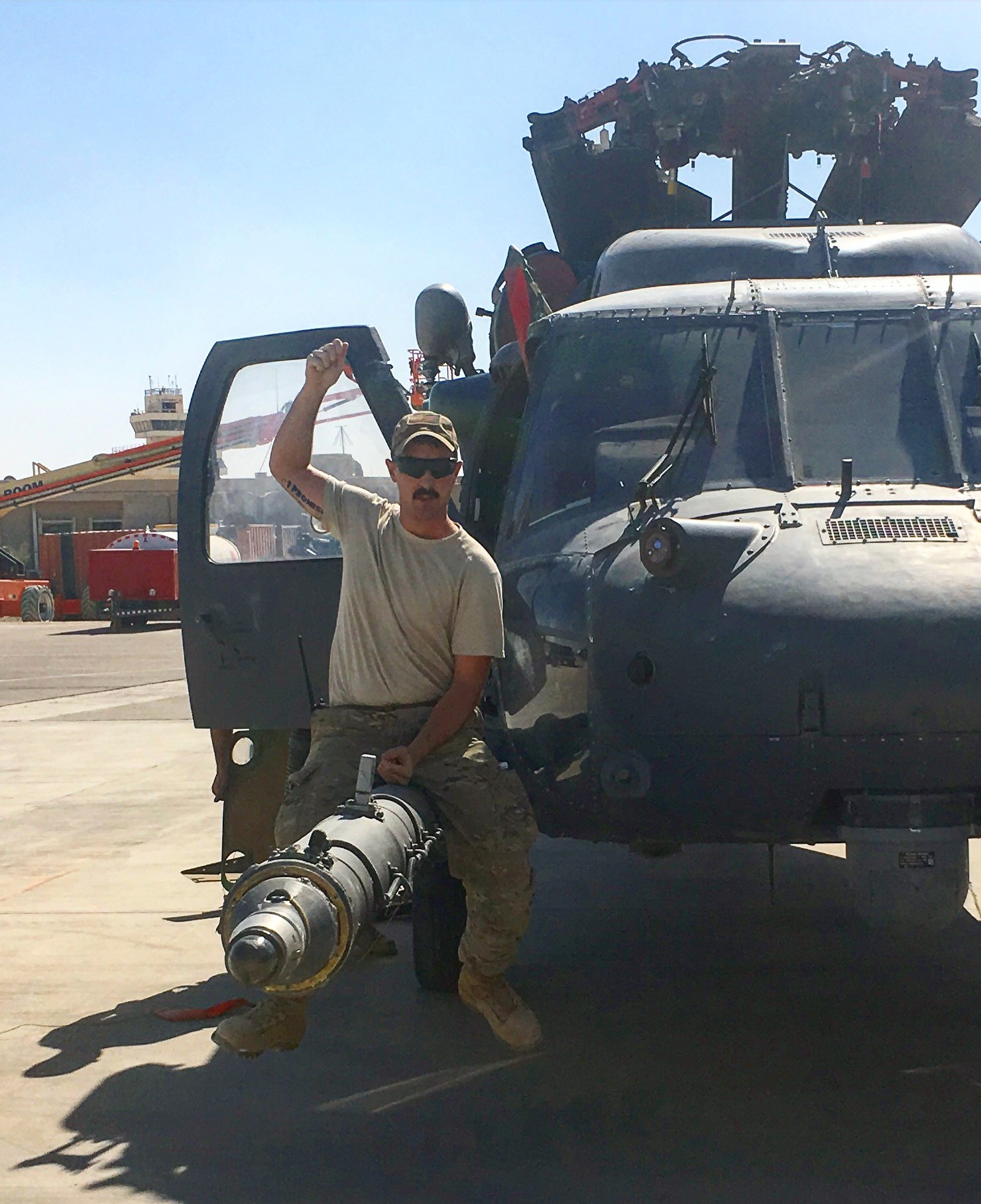 Founder of Combat Morale Apparel on the flight line next to a helicopter refueling probe